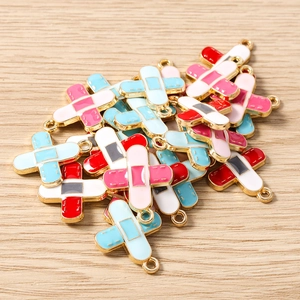 Macro shot of colorful enamel band-aid charms with golden alloy edges for DIY jewelry making