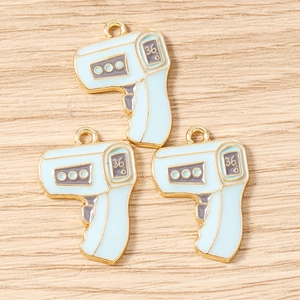Three light blue enamel thermometer gun charms with gold metal bases for DIY jewelry making