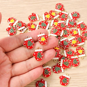 Detail of red enamel Christmas glove charms with green tree patterns for DIY jewelry