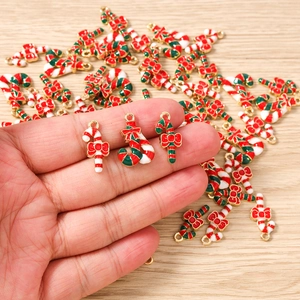 Close-up of Christmas candy cane alloy pendants with red bows for DIY jewelry making