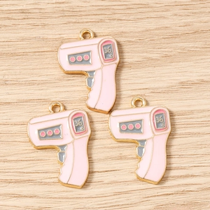 Detailed macro view of pink thermometer charms for DIY jewelry making accessories