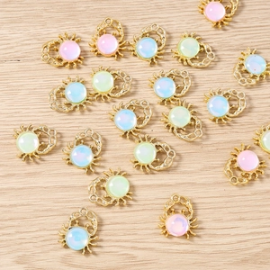 Macro shot of colorful crab-shaped alloy pendants with opal stones for DIY jewelry making
