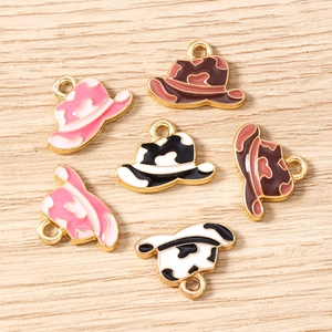 Detailed close-up of alloy cowboy hat charms with colorful camo and cow print patterns