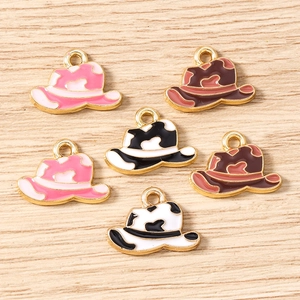 Flat lay of colorful enamel cowboy hat charms in cow print for DIY jewelry making