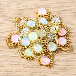 Detailed macro view of macaron gem crab charms with golden alloy bases for DIY jewelry