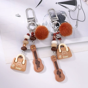 Boho tassel keychain with brown faux fur ball, beaded string and guitar charm