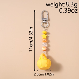 Detail view of yellow basket keychain with star charm showing 11cm length and 8.3g weight