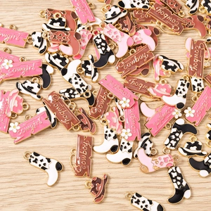 Detailed macro view of enamel western cowboy boot and hat pendants for DIY jewelry making