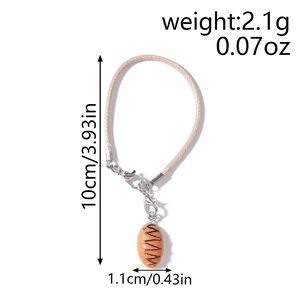 Detailed view of bread-shaped charm on phone strap with precise weight and size dimensions