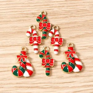 Detailed macro view of festive red and green Christmas candy cane charms with gold alloy edges