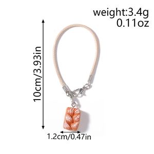 Detail view of miniature bread charm showing 10cm length and 3.4g weight specifications