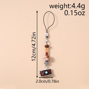 Macro detail of a vintage brown camera charm with marble and amber beads keychain