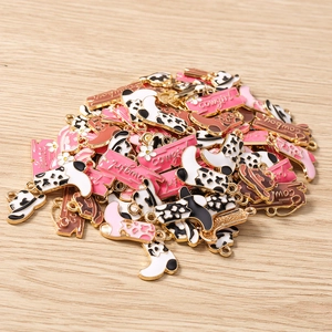 Detailed macro view of western cowgirl boot and hat alloy charms for DIY jewelry making