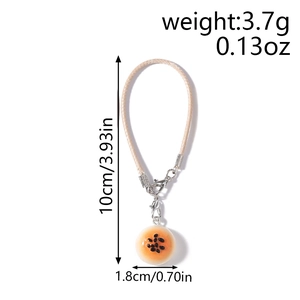 Detail view of bread donut charm with size specs 10cm length and 1.8cm diameter
