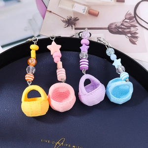 Colorful mini woven basket keychains with star charms in yellow, pink, purple and blue