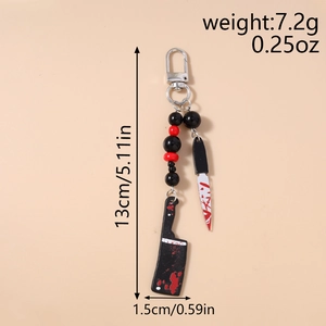 Detail view of bloody knife keychains with size dimensions and weight in inches and grams