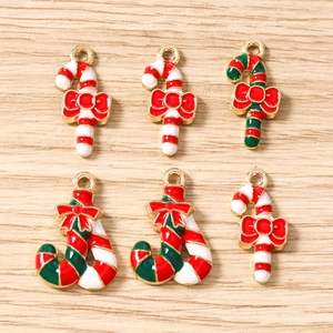 Detailed view of six candy cane pendants with red bows for DIY Christmas jewelry making