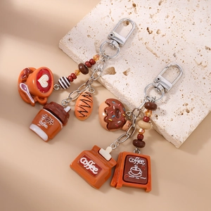 Creative coffee and pastry keychain featuring miniature latte heart and donut charms