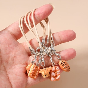 5-piece set of realistic mini bread and cake charms with woven straps for bags