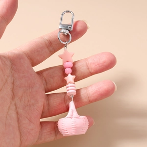 Detailed view of pink beaded keychain with star beads and mini woven basket charm