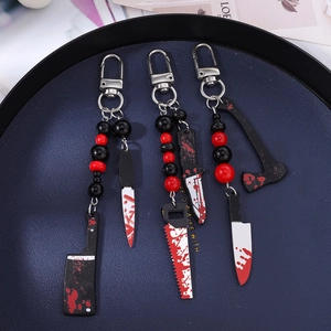 Halloween keychain set with bloody acrylic knife, saw and axe charms and red beads