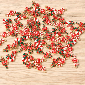 Macro view of Christmas candy cane pendants with red bows for DIY jewelry making