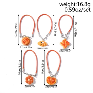 Detailed close-up of 5 resin food pendants with orange cords and silver clasps