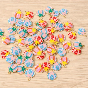 Flat lay of colorful enamel Christmas star pendants on a natural wood surface
