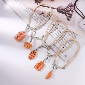 Set of 5 realistic food charms including croissants and waffles with woven cords