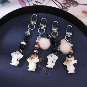 Cute striped beaded cat keychain set with plush pompom charms for bags and purses