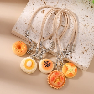 Five pieces set of realistic resin food charms including donuts and buns for bags and keys