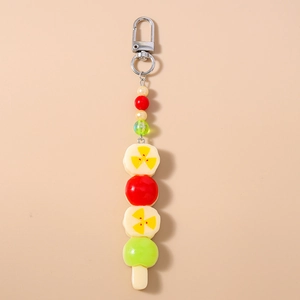 Détail macro d'un porte-clés brochette de fruits avec perles de banane et pastèque en résine
