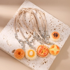 Detailed view of 5 realistic miniature bread charms with woven cords and metal clasps