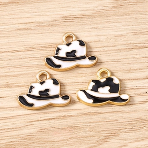 Detail of cow print enamel cowboy hat charms with gold edges for DIY jewelry making