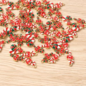 Detailed close-up of candy cane charms with red bows for Christmas DIY jewelry making