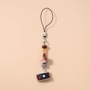 Detail of beaded camera charm with turquoise beads and brown marble texture beads