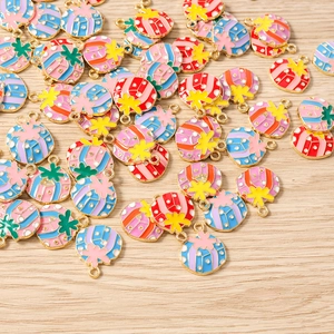 Macro detail of colorful gift box charms for Christmas DIY jewelry making on wood background