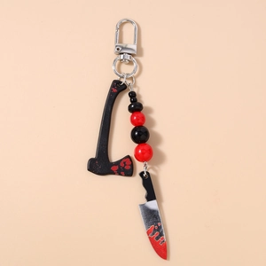 Detail of Halloween keychain with bloody axe, kitchen knife charms and red black beads