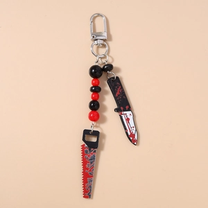 Detail view of Halloween beaded keychain featuring bloody knife and saw charms