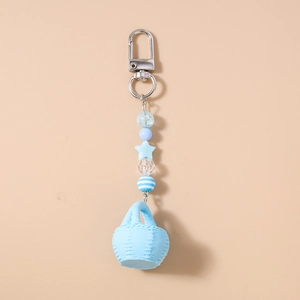 Detailed shot of handmade blue beaded keychain featuring a star and mini basket charm