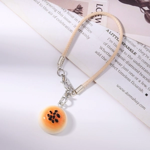 Detailed close-up of realistic faux donut bun keychain with textured weaving rope and lobster clasp