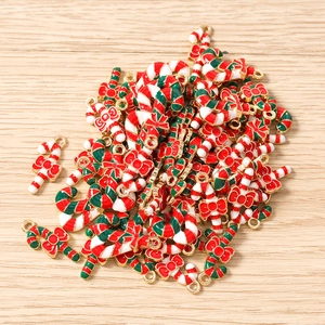Detailed macro view of colorful candy cane charms with red bows for Christmas DIY jewelry