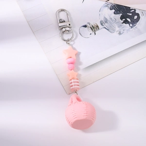 Detailed view of pink basket keychain with stars and beads on a decorative card