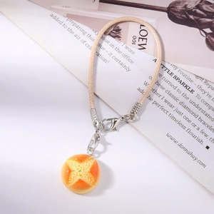 Creative realistic melon bread charm with a beige braided strap and silver lobster clasp