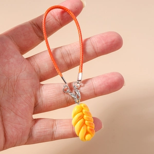 Detailed view of the woven orange strap and realistic braided bread charm on handheld phone