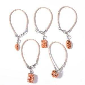 Creative bread themed keychain set with croissant and baguette charms on braided ropes