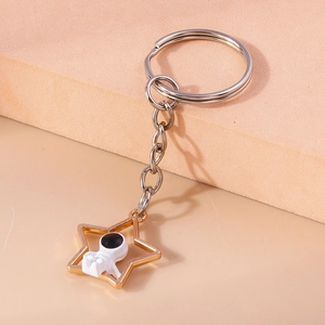 Porte-clés astronaute créatif avec cadre étoile dorée et figurine d'espace blanche