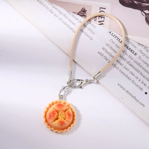 Detail of creative donut bread pendant with beige woven strap and silver lobster clasp