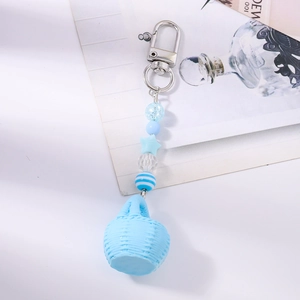 Detail of light blue beaded keychain with mini woven basket star charms and silver clasp