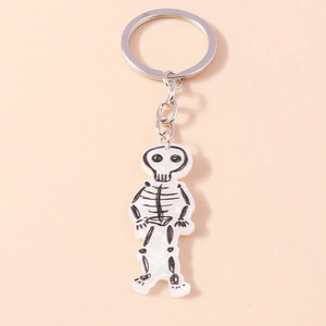Detail of cartoon skeleton acrylic keychain with silver metal ring on pink background